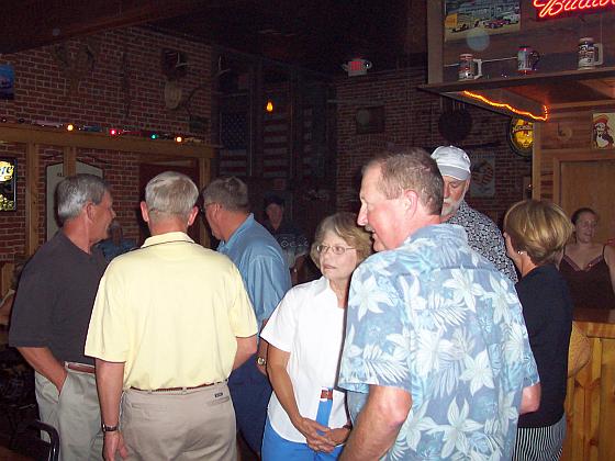 Susan Carlson Johnson (center) and Rex Schwaninger try to remember who is who, while Bruce Melberg and Sherry Sandberg McClymont visit.