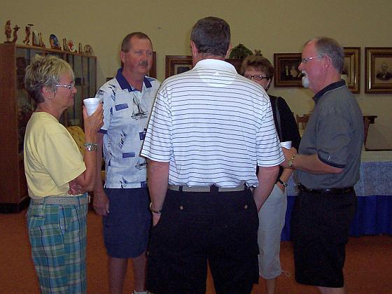 Becky Hilsabeck (left)  Rex Schwaninger,  Tom Hilsabeck (back to camera) visit with Terry and Mary Lucas Gugle.