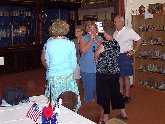 Sue Hasselquist (hands on face) talks to Patty Morris Hild, while Susan Buettner Langenberg and Dick Damrow visit with 2 other classmates.