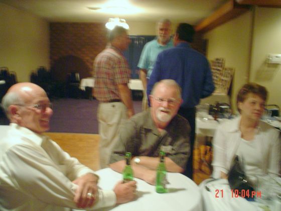 Bill Cummins visits with Terry and Mary Lucas Gugle.